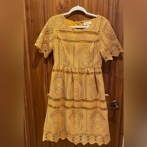 Golden yellow true embroidery. Lightly worn